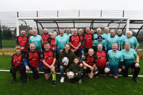 Craig Mackail-Smith (front, centre), with his son Jude, alongside Netherton walking football teams at the official opening of the new 3G pitch at The Grange. Photo: David Lowndes.