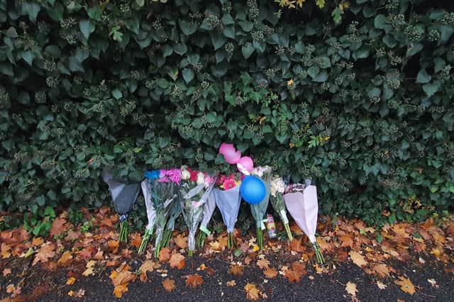 Flowers left close to the scene of the incident. .