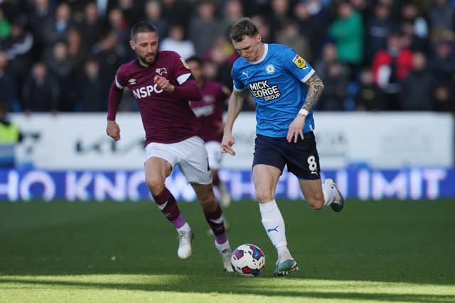 Jack Taylor of Peterborough United is tracked by Conor Hourihane of Derby County . Photo: Joe Dent/theposh.com.
