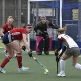 Lauren Finding (red) in action for City of Peterborough Ladies 2nds v Norwich Dragons. Photo: David Lowndes