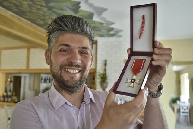 House of Feasts restaurant owner Damian Wawrzyniak with his Polish medal
