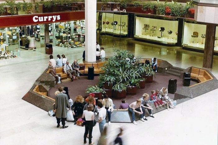 Like seemingly everywhere else in the country, Peterborough found itself with a glitzy new shopping centre to enjoy in the 1980s. Here we see shoppers taking a break from their   consumer spending in the old seating area opposite the Currys electrical store in Queensgate