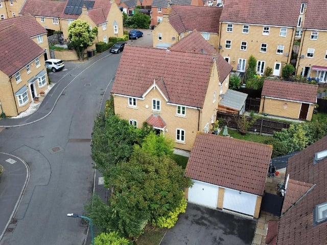 An aerial view of the house and the driveway leading to the garage