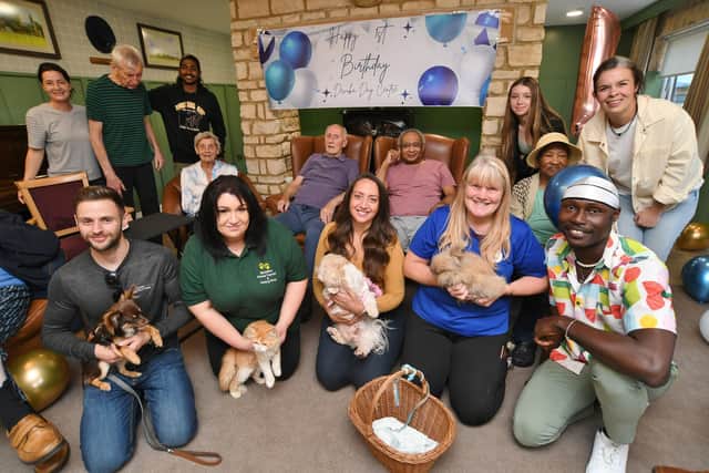 Michelle Daughtrey and staff from her Animal Therapy Petting Party visiting residents at the dementia unit at Castor Lodge Care Home, which was celebrating its first birthday.