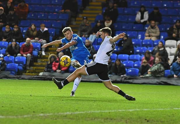 Harrison Burrows scores for Posh with a deflected shot against Crawley. Photo: David Lowndes.