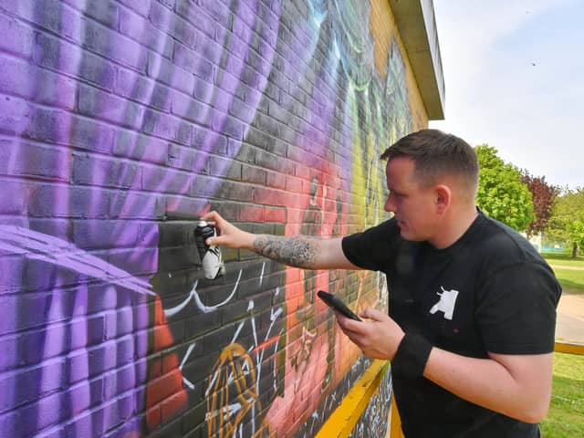 Nathan Murdoch creating his latest mural at the Key Theatre.