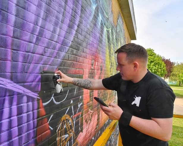 Nathan Murdoch creating his latest mural at the Key Theatre.