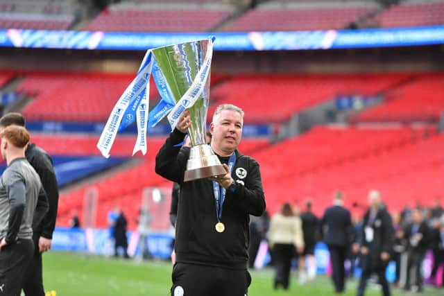 Darren Ferguson with the EFL Trophy won by Posh at Wembley last season. Photo David Lowndes.