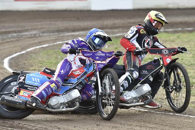 Ben Cook of Panthers battles for the lead against Belle Vue. Photo: David Lowndes.