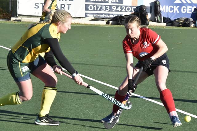 Hockey action from City of Peterborough Ladies (red) v Norwich City. Photo: David Lowndes.