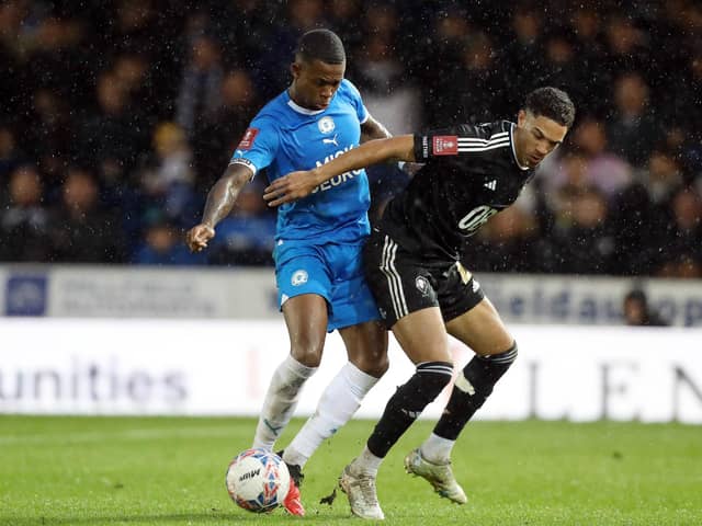 Zak Sturge of Peterborough United battles for the ball against Salford City. Photo: Joe Dent/theposh.com
