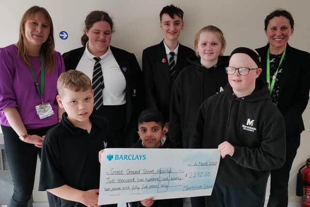 Students and staff at Marshfields school in Dogsthorpe with their charity fundraising cheque for Great Ormond Street.