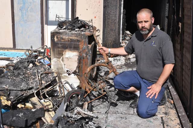 Eddie MacGregor examines the damage caused by the fire