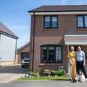 Alison O’Malley and Terry Baker and their pet dog Teddy outside their new house at Bellway’s Stilton Gate development in Stilton, where all the homes have now been completed