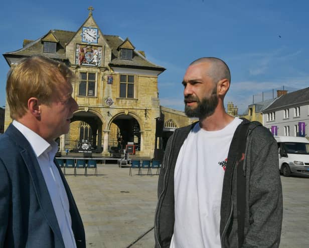 Andrew Bowley - who was stabbed five times in 2017 - recounts his experiences to MP Paul Bristow at the 'Knives Over Lives' community awareness event in Cathedral Square.