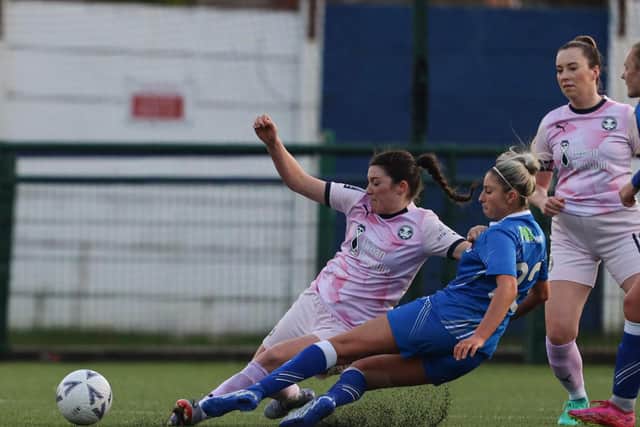 Jess Driscoll (pink) makes a tackle for Posh Women at Sutton Coldfield. Photo: Darren Wiles