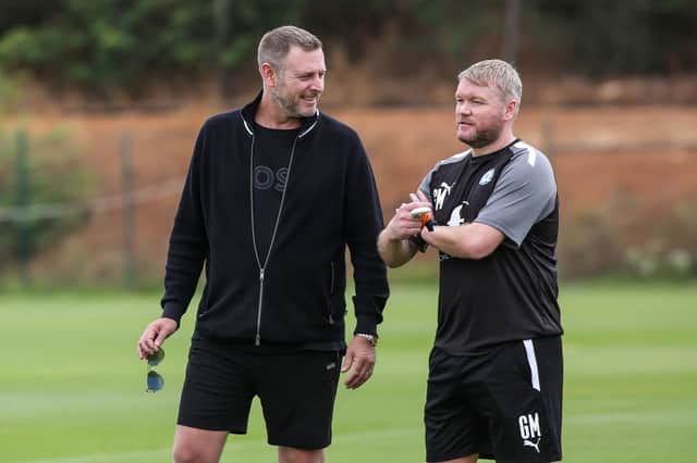Posh chairman Darragh MacAnthony (left) with manager Grant McCann.