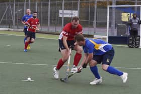 Hockey action from City of Peterborough (red) v Stourport at Bretton Gate. Photo: David Lowndes.
