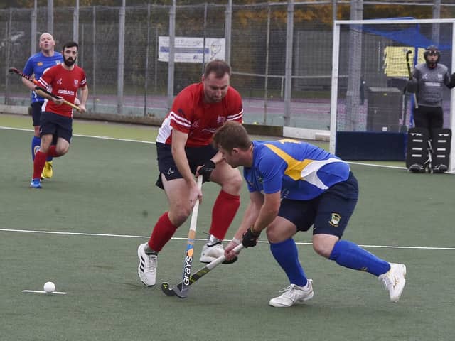 Hockey action from City of Peterborough (red) v Stourport at Bretton Gate. Photo: David Lowndes.