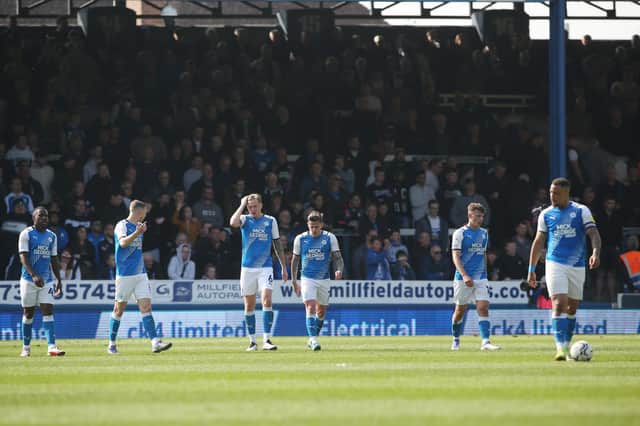 Peterborough United players cut dejected figures after Nottingham Forest score the opening goal of the game.