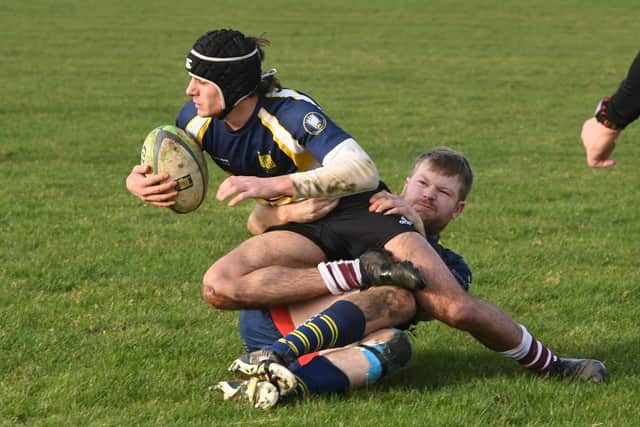 A March Bear is tackled by a Thorney player. Photo: David Lowndes.