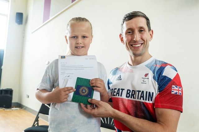 ParalympicsGB high jump star Jonathan Broom-Edwards with Kacey, a pupil at New Road Primary School in Whittlesey, where he spoke about the importance of healthy eating before going on to officially open the new Aldi store in Whittlesey.