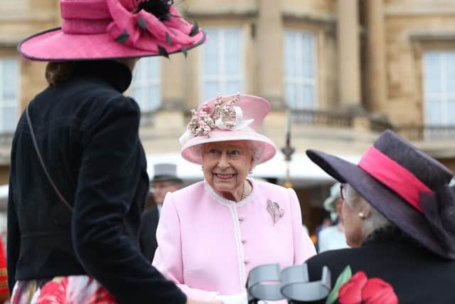 Queen Elizabeth II meets guests at the Queen's Garden Party in Buckingham Palace in 2019.