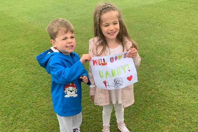 Del Dunworth's children - Arlo, 3, and Myla, 4 - cheering on their dad on.