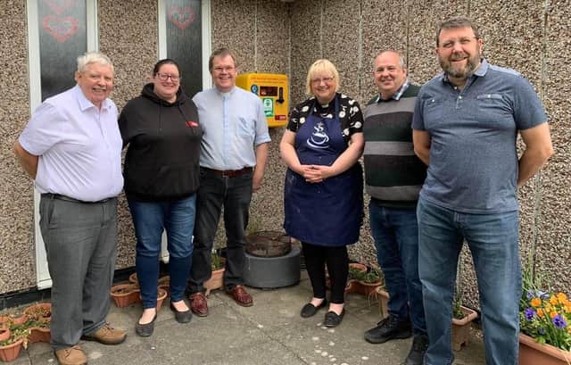 Cllrs Brian Rush (left), Ray Bisby and Chris Harper (right) with Gemma Wells from Gemma's Hearts and Rev Andrew and Carol Avery with the new defibrillator.