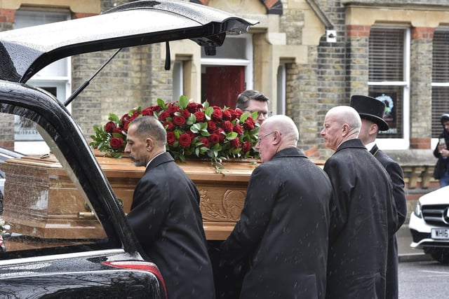 The funeral procession arrives at the church.