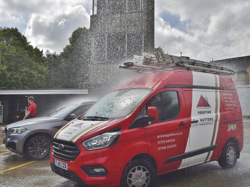 Firefighters wash cars for members of the public.