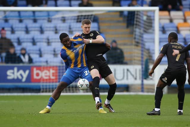 Josh Knight battles against Christian Saydee of Shrewsbury Town. Photo: Joe Dent.