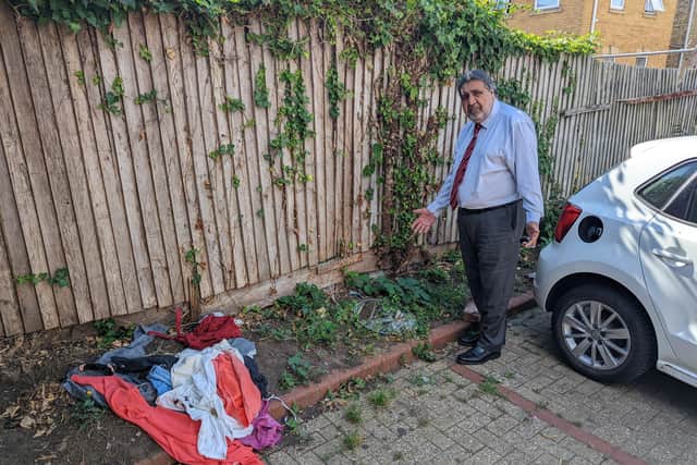 Councillor Mohammed Sabir with some of the rubbish dumped in the car park