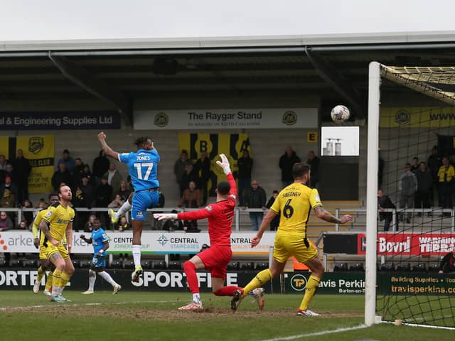 Ricky-Jade Jones of Peterborough United heads in the opening goal against Burton Albion. Photo Joe Dent/theposh.com