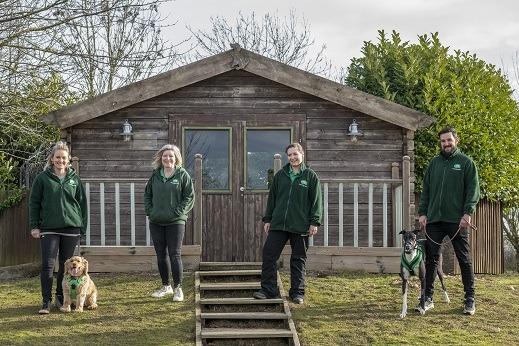 Lizzie with Reggie, Elaine, Katie V and Chris R with Tom the dog outside the pen of the Hope meeting pen