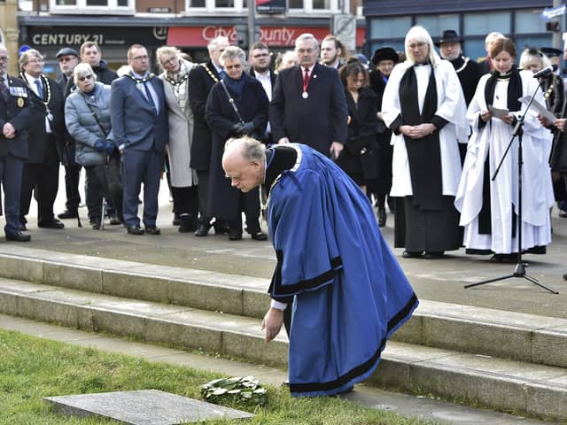 Peterborough Holocaust Memorial Day commemoration.  Deputy Mayor of Peterborough Nick Sandford lays a wreath at the Holocaust memorial plaque at St John's Church.