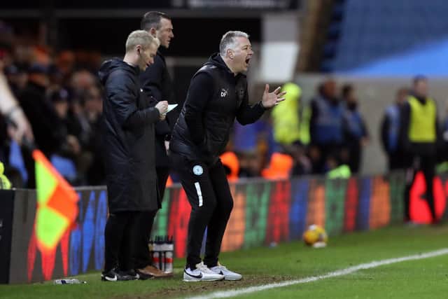 Neill Collins behind Darren Ferguson during the meeting between the sides this season. Photo: Joe Dent.