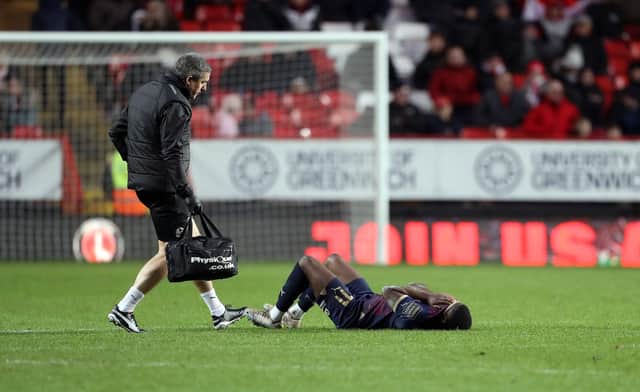 Kwame Poku left the pitch after appearing in a lot of pain. Photo: Joe Dent.