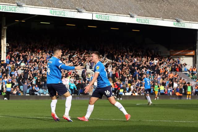 Ronnie Edwards and Harrison Burrows of Peterborough United celebrate the goal against Cambridge. Photo: Joe Dent/theposh.com.
