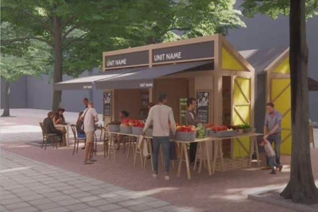 This image shows how the special wooden kiosks in Peterborough's new outdoor market in Bridge Street will appear once built. But the time taken to construct the kiosks has delayed the market's opening for a second time.