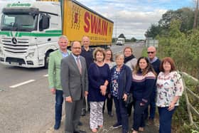 Shailesh Vara MP (second from left) and John Bradshaw (second from right) alongside the A1 with other attendees from the meeting.