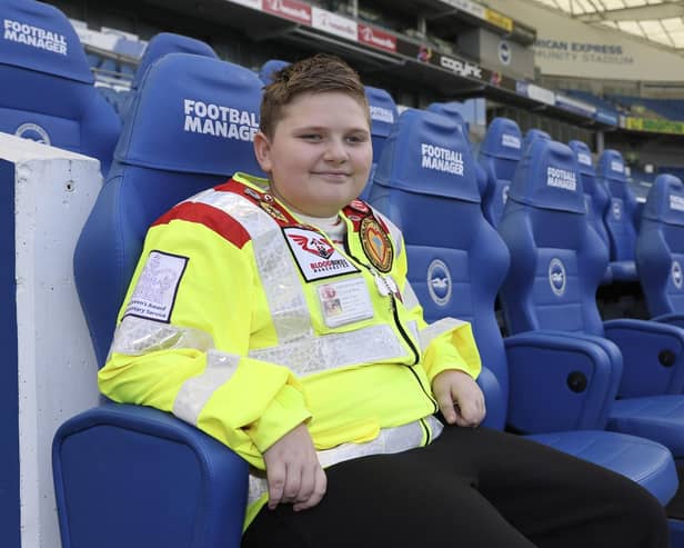 Caiden Rolph, 11, pictured in the dug out at The Amex, home to BHAFC in Falmer, East Sussex. The visit completes his tour of UK Premiership Football Clubs raising money for blood bike groups across the UK (image: BHAFC/Paul Hazlewood).