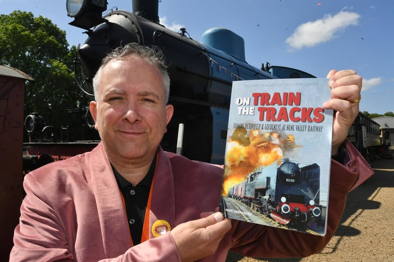 The reunion event's organiser, Marc Hernandez, with his new book On The Train Tracks', which tells the stories of Bond films that have been shot on location at Nene Valley Railway.