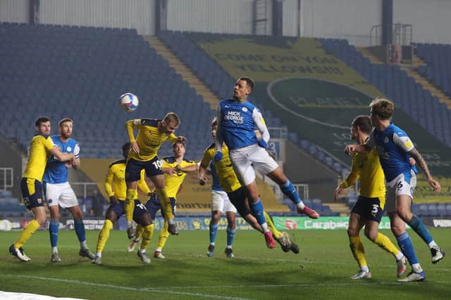 Jonson Clarke-Harris of Peterborough United heads goalwards against Oxford United in March 2021. Photo: Joe Dent.