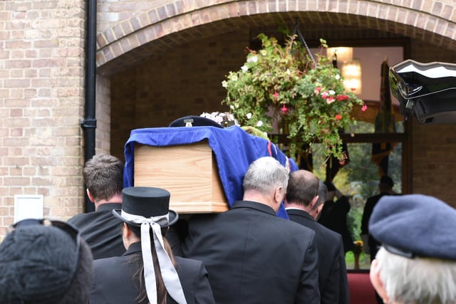 The coffin is taken into the crematorium