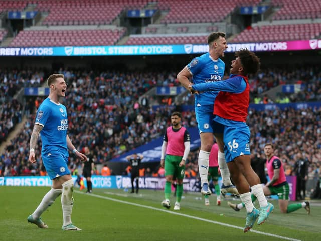 Posh skipper Harrison Burrows celebrates the winning goal at Wembley with substitute James Dornelly. Photo Joe Dent/theposh.com.