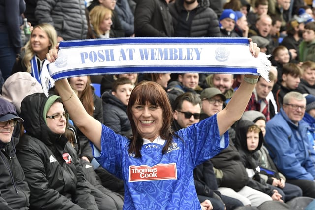 Peterborough United fans are pictured watching the crucial win over Derby County on 25th March 2023.