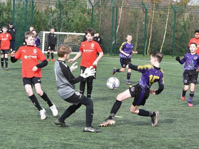 Action from Peterborough Regional Talent Centre  Under 12s (red) v Wisbech St Mary at Hampton Gardens School. Photo: David Lowndes.