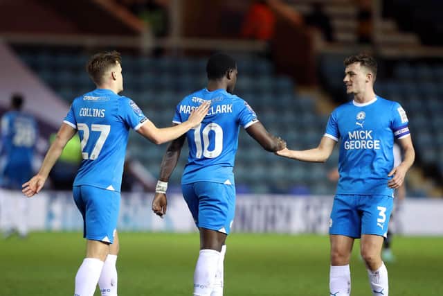Ephron Mason-Clark of Peterborough United is congratulated by team-mates after scoring. Photo: Joe Dent/theposh.com.