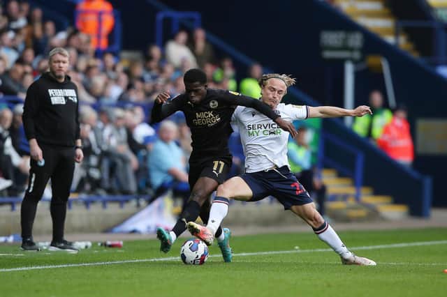 Kwame Poku of Peterborough United battles with Kyle Dempsey of Bolton Wanderers. Photo: Joe Dent/theposh.com